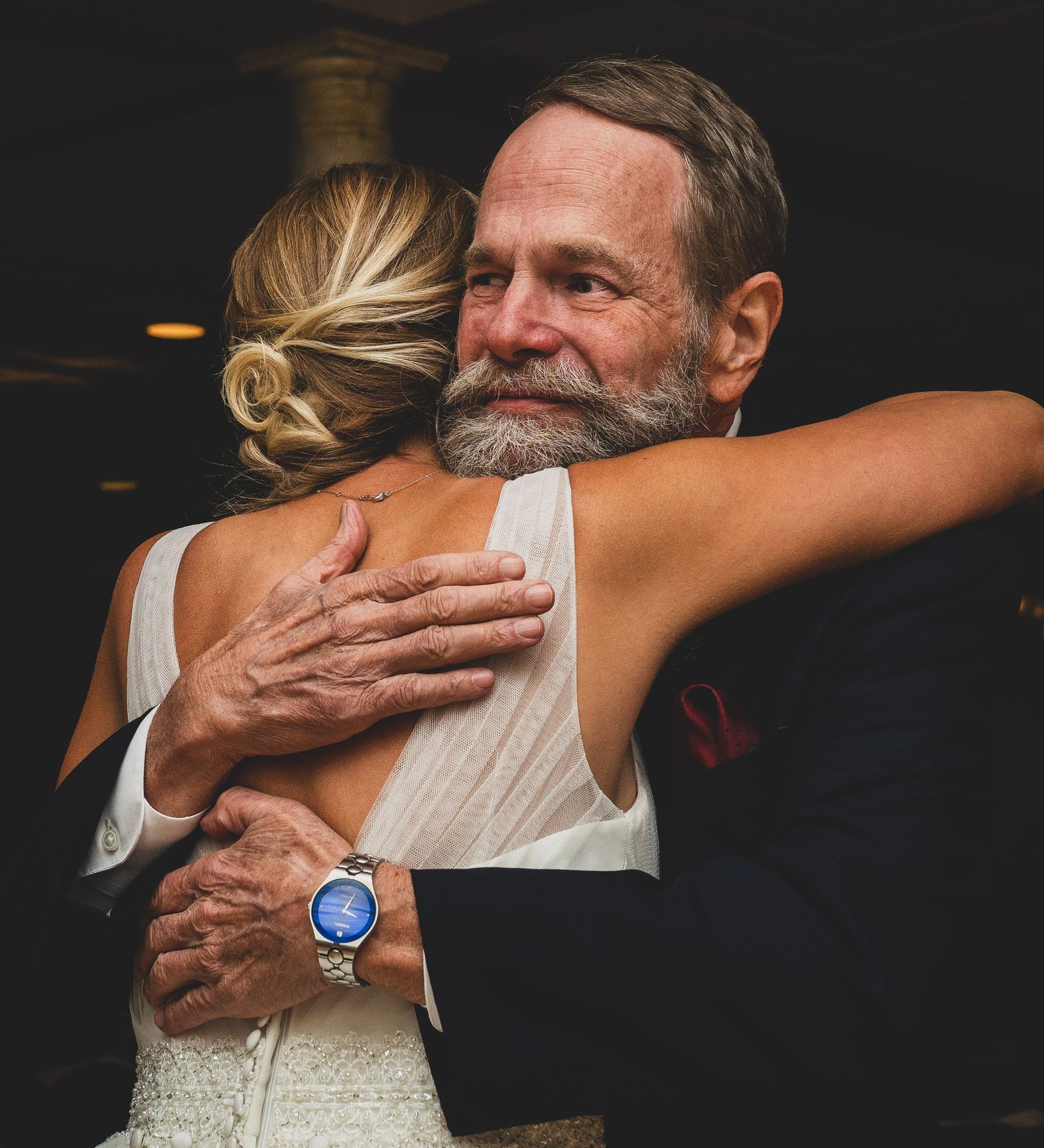 Emotional wedding moment capturing a father-daughter embrace, showcasing love and connection.